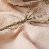 ivy leaf stacking rings on dried stem with pink cloth