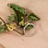 silver ivy leaf ring on pink cloth and dried flowers