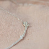 Silver Textured Twig Necklace on pink cloth