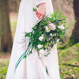 bouquet of flowers held by bride's side