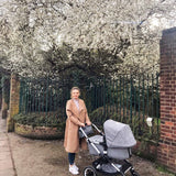 woman under tree with pushchair