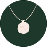 illustration of relic pendant on green circle background