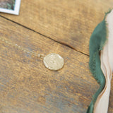 gold relic pendant on wood background