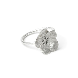 silver flower ring on white background