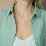 model wearing cow parsley silver necklace and green shirt