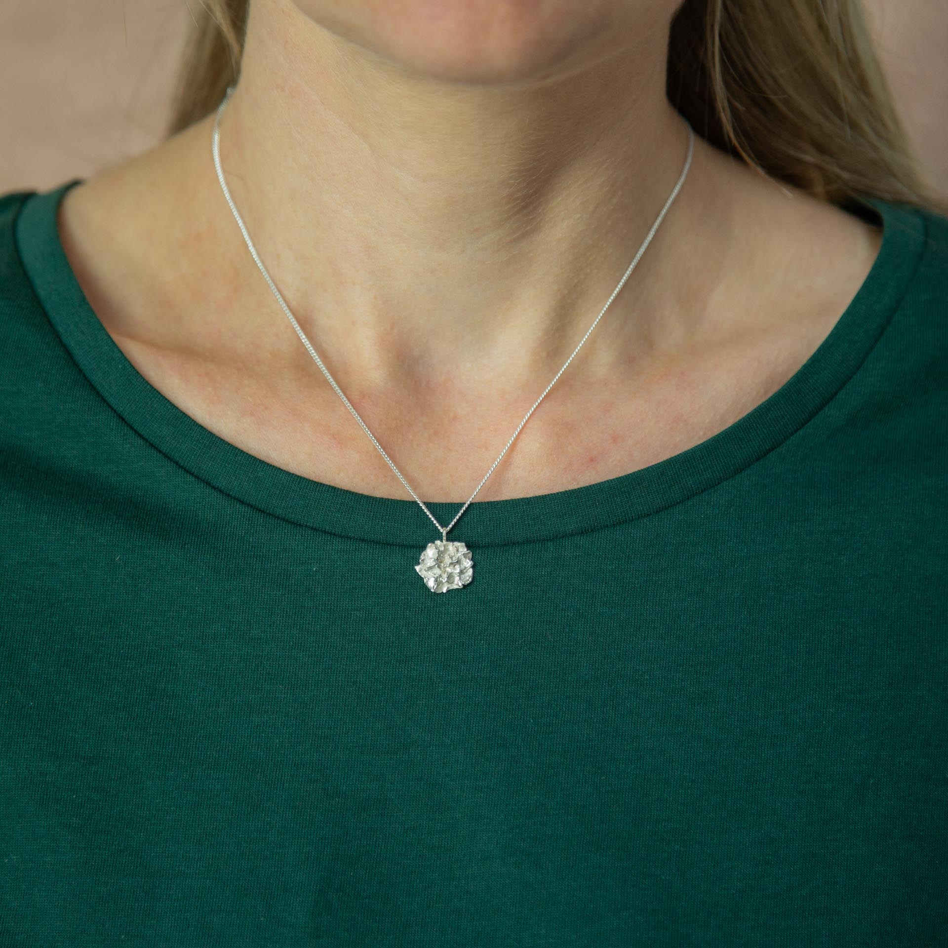 Silver Hedgerow Flower Drop necklace modelled worn with green t-shirt