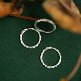 silver scattered seed rings on green background