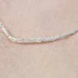 Silver Textured Twig Necklace on pink cloth