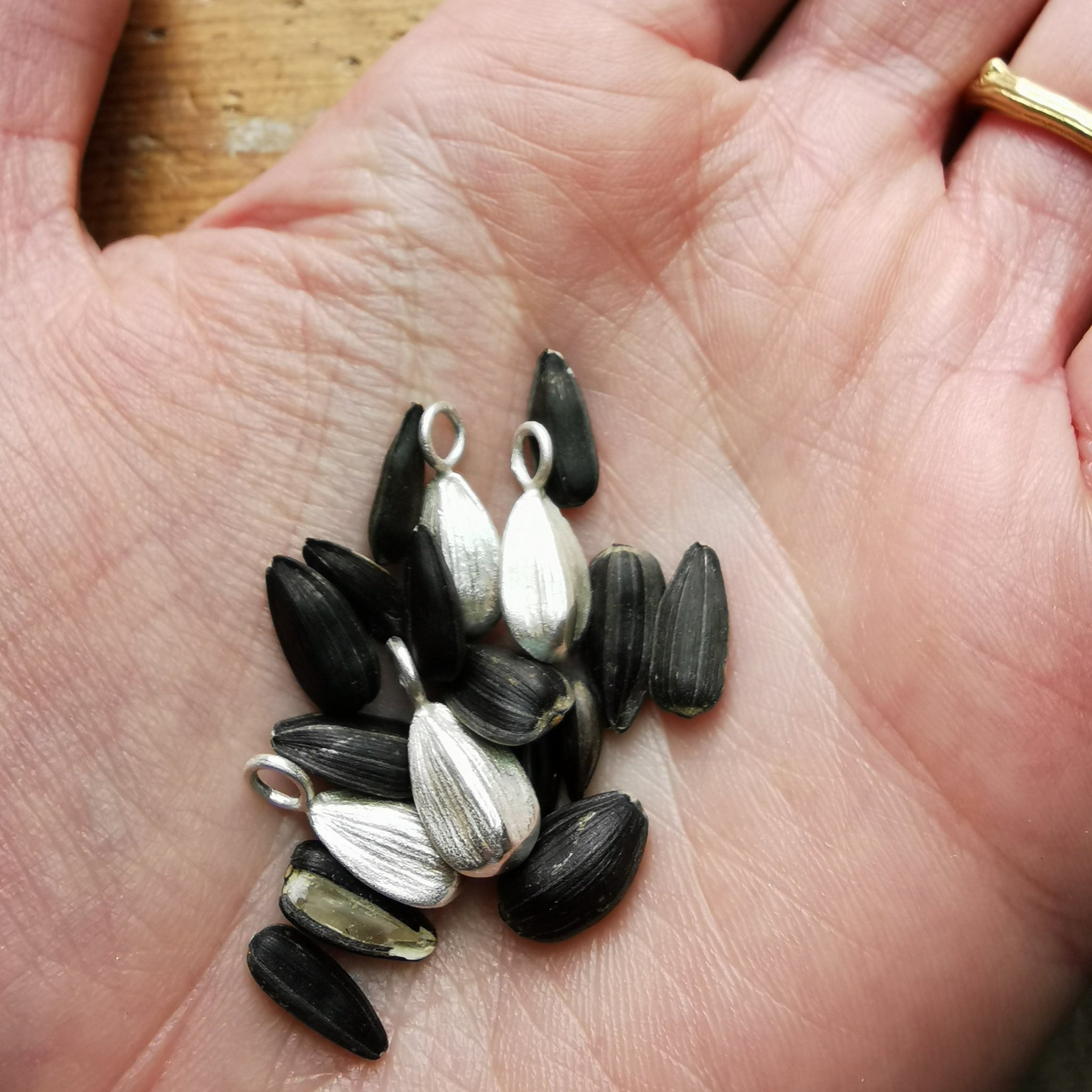 silver sunflower seed charm