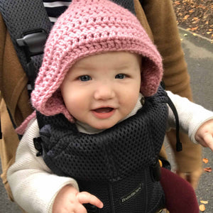 child smiling wearing pink hat
