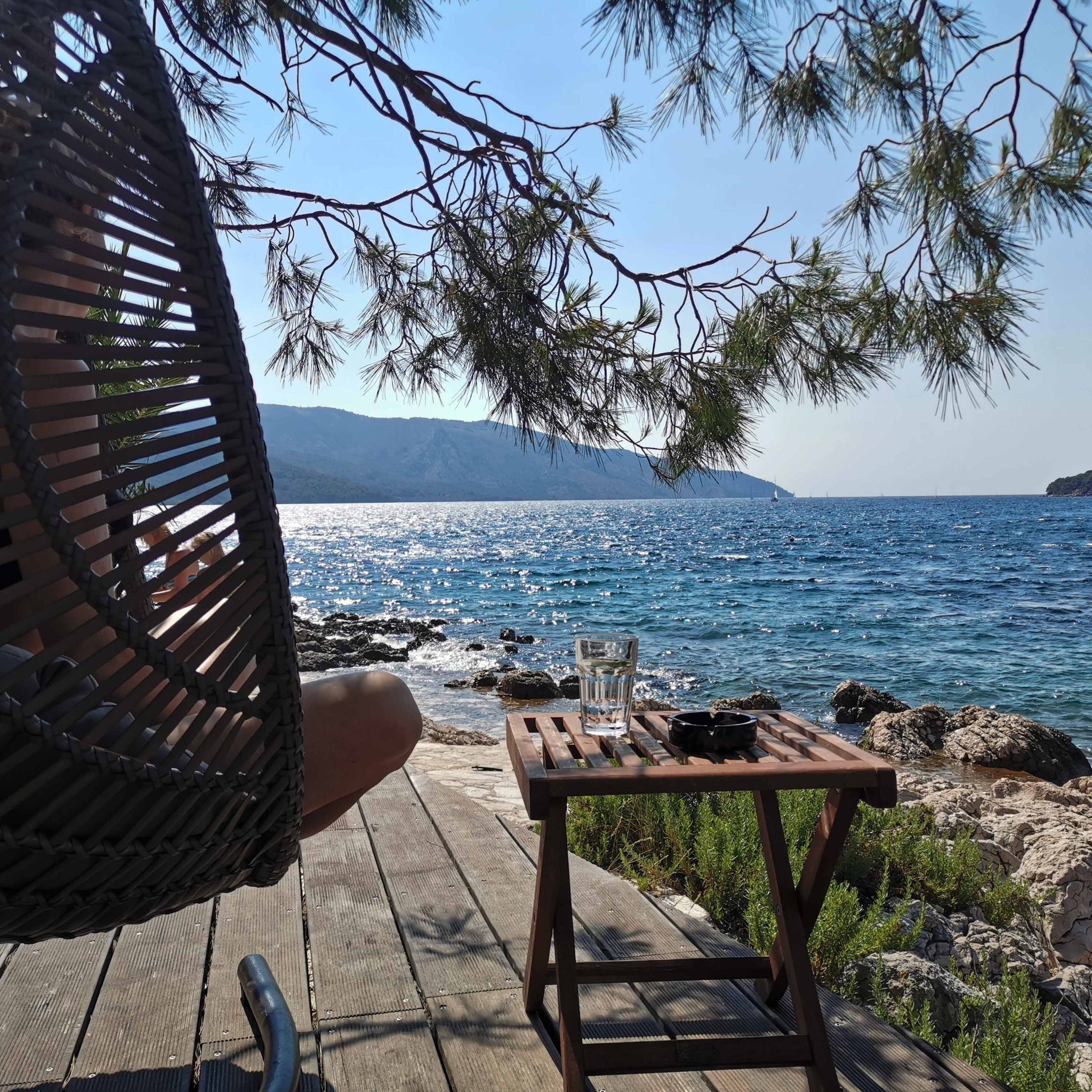 swinging wicker chair overlooking the ocean
