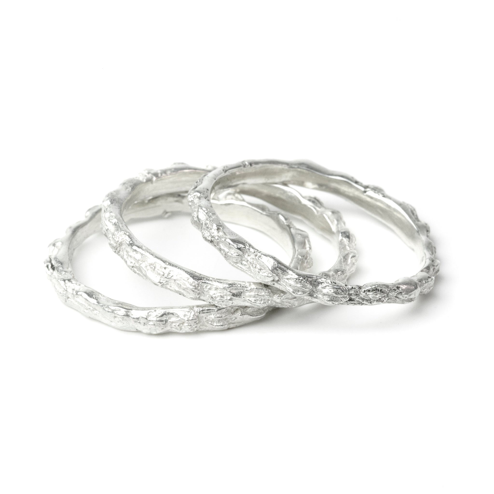 silver scattered seed rings on white background