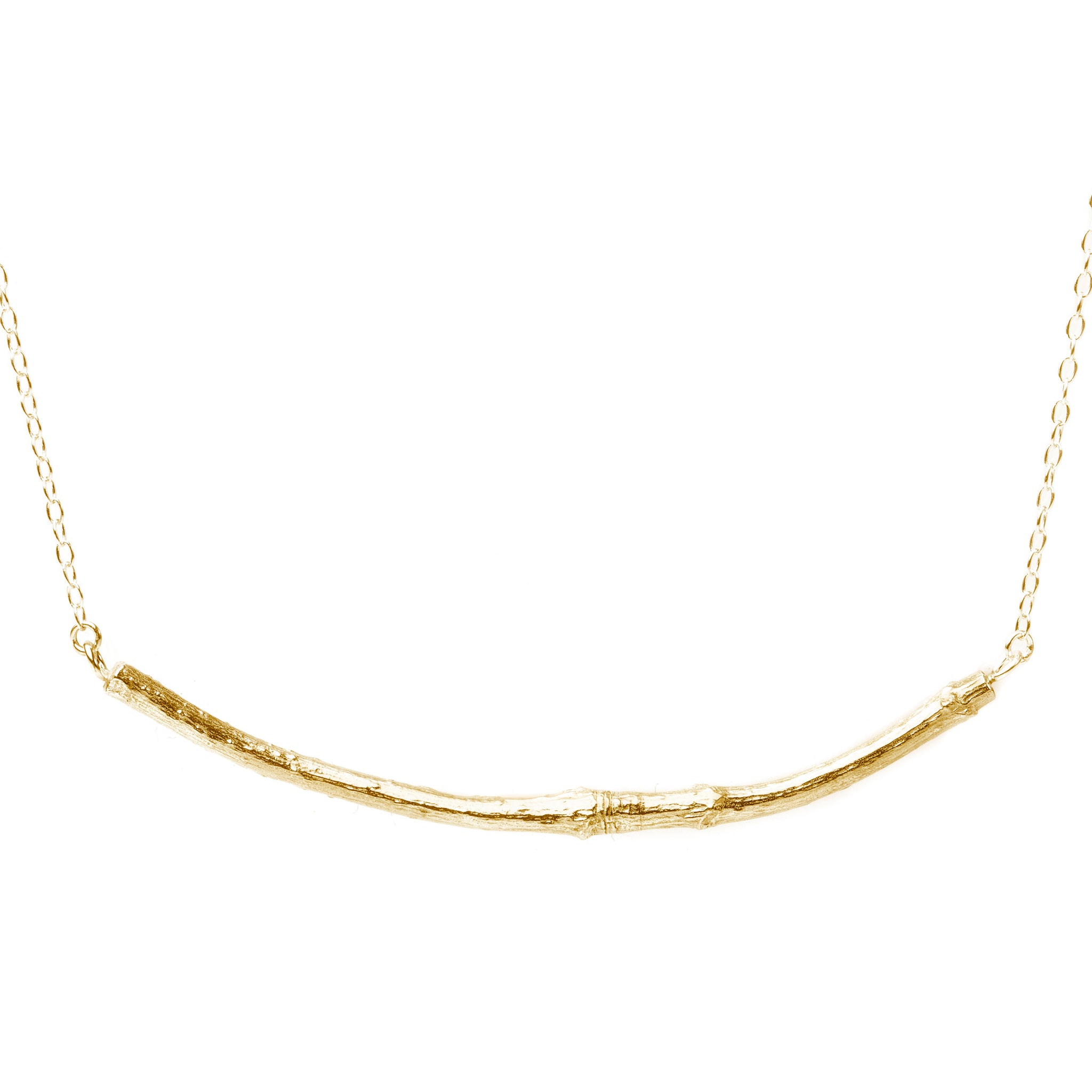 gold smooth twig necklace on white background