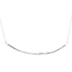 silver smooth twig necklace on white background