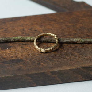 gold Stem Stacking Ring on wood