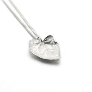 silver ivy leaf necklace on white background 